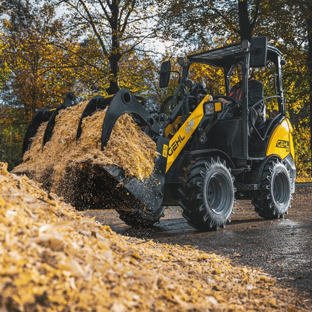 Kleine graafmachine voor het verplaatsen van mulch of schepgoed in een tuin of van locatie.