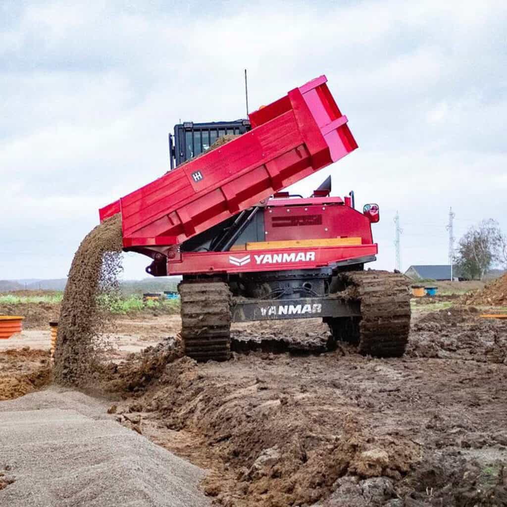 1. Groene en rode bouwmachine bij grondbewerking op de bouwplaats.