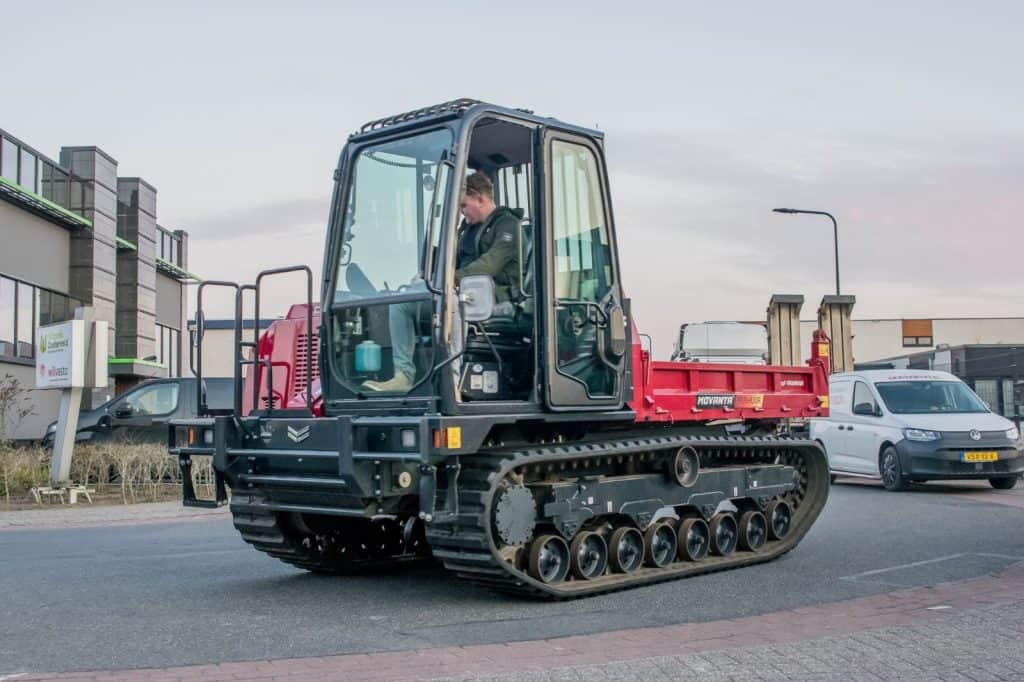 Klein bedrijfsbandenruimer op straat, geschikt voor wegenbouw en asfaltverwerking.