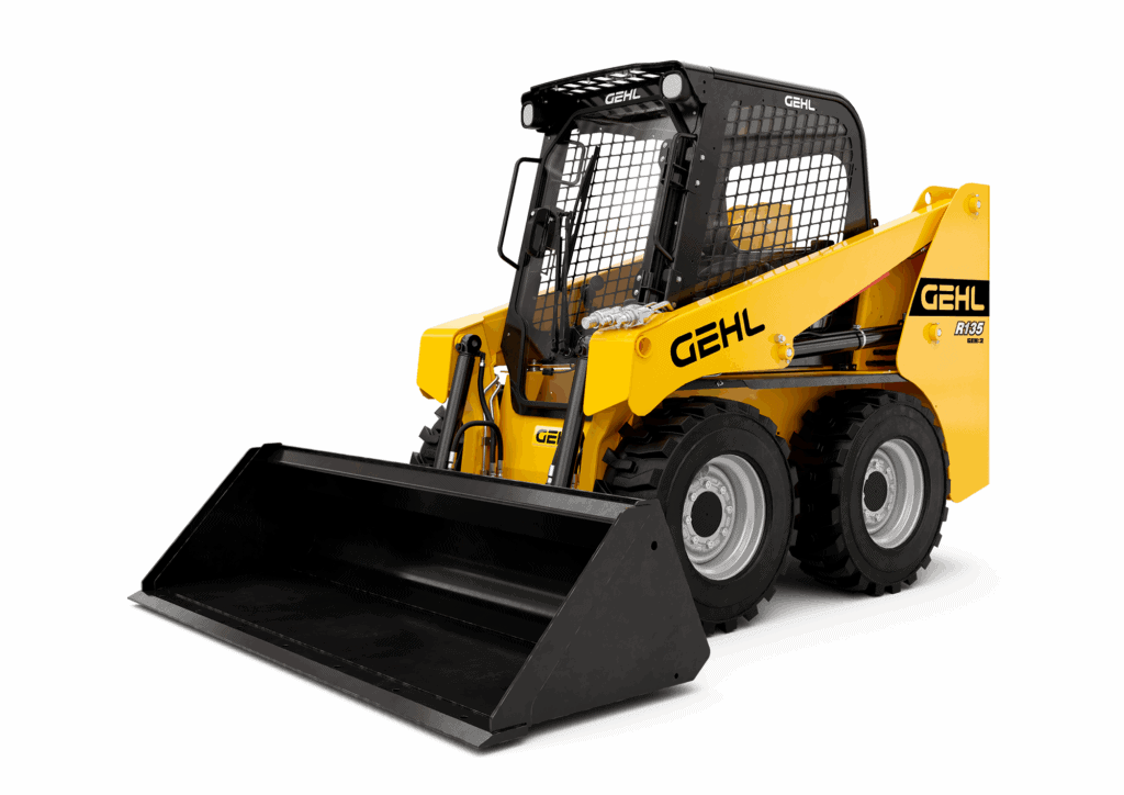 Kleiner wielzwenkbare wiellader met cabine en oprijplaat, geschikt voor bouw en tuinwerk.